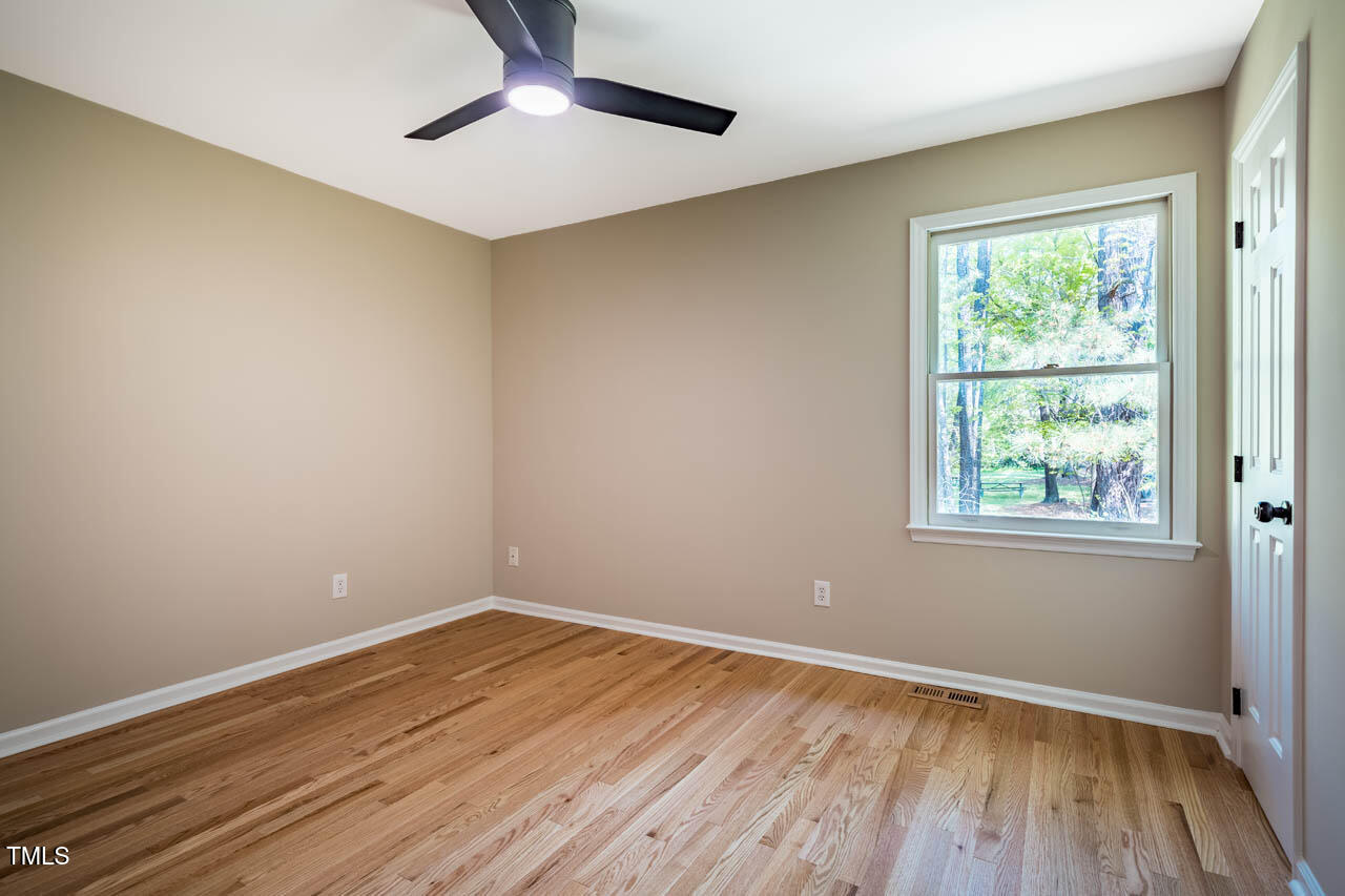 103 Windhover Drive Chapel Hill, NC 27514 - Photo 41 of 61 a view of an empty room with wooden floor and a window
