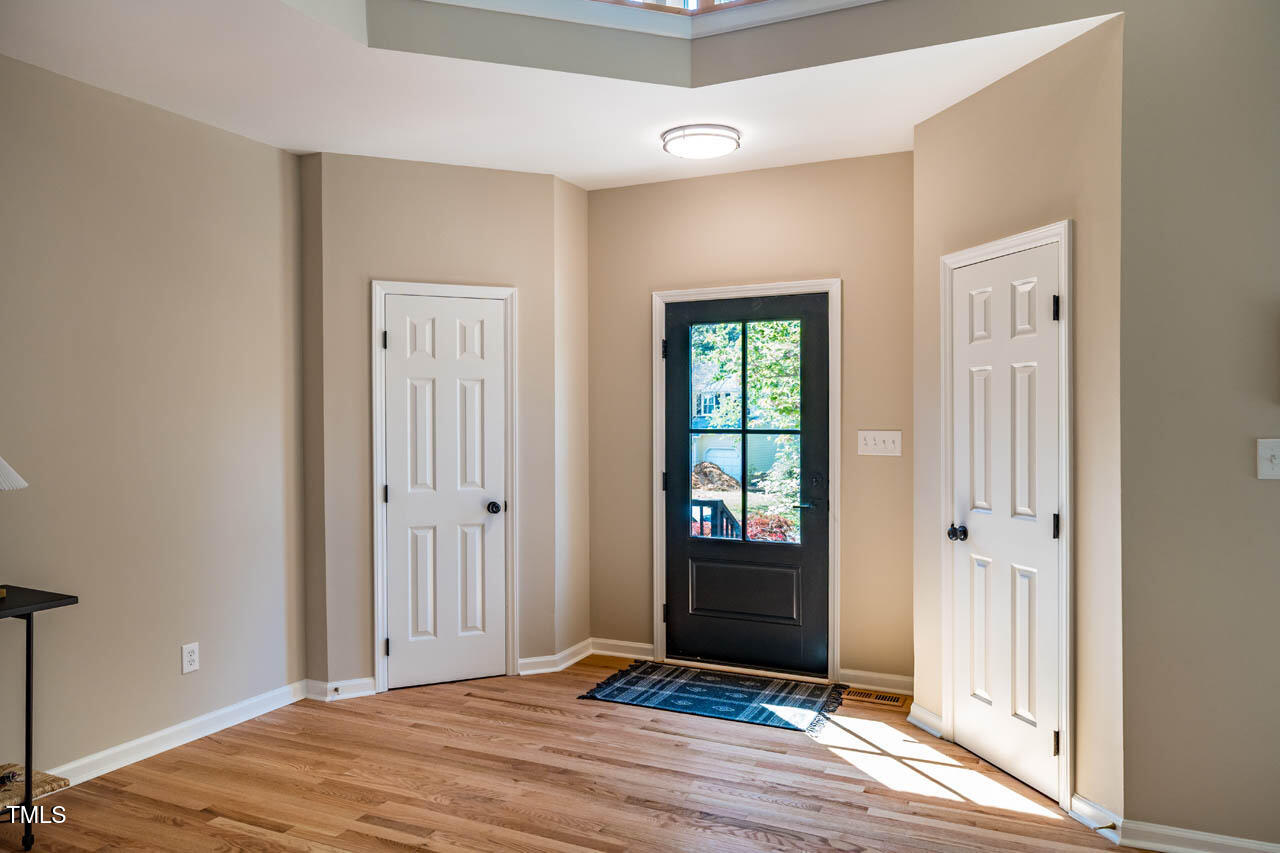 103 Windhover Drive Chapel Hill, NC 27514 - Photo 6 of 61 a view of a livingroom with wooden floor and a bathroom