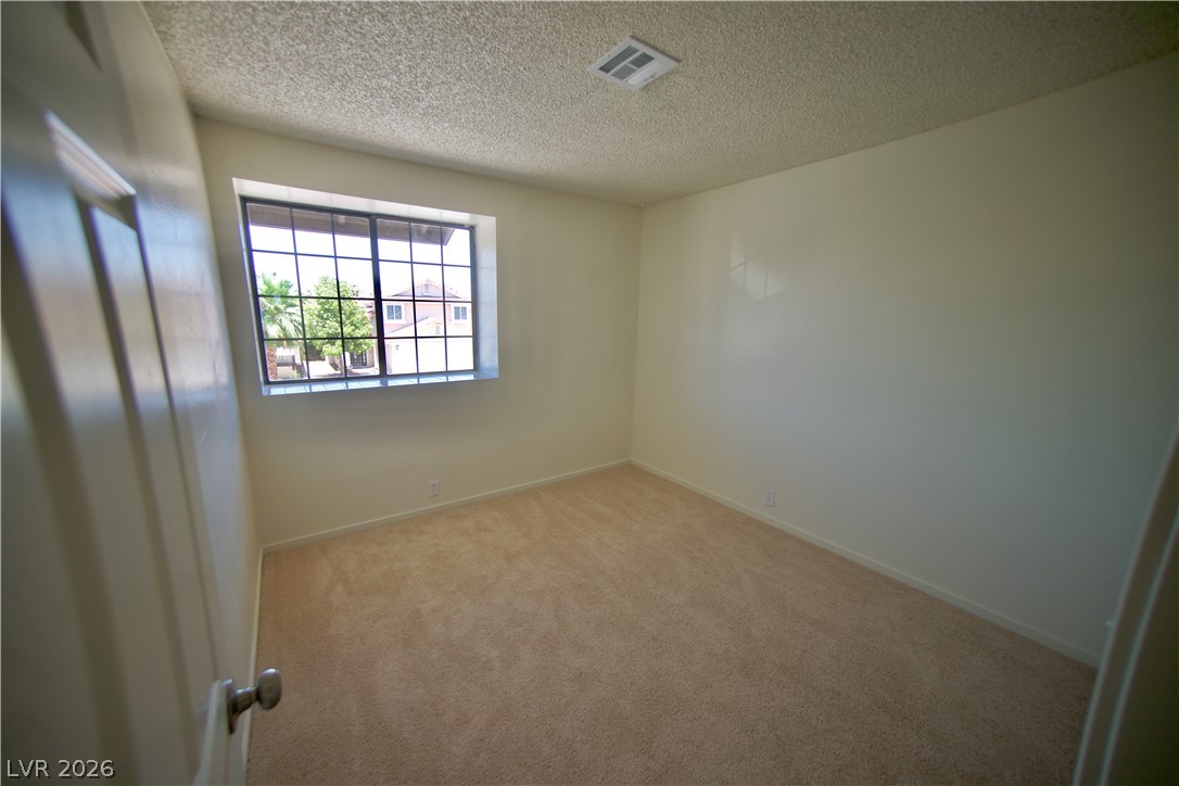 6501 Hartwood Road Las Vegas, NV 89108 - Photo 19 of 32 A well-lit room with plush carpet, featuring a large window that brightens the interior.