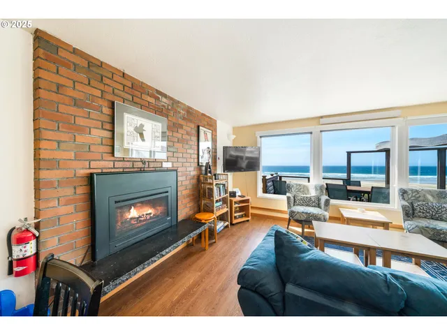 a living room with furniture a fireplace and a floor to ceiling window