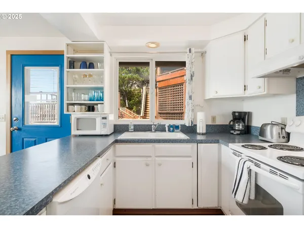a kitchen with stainless steel appliances granite countertop a sink stove and cabinets