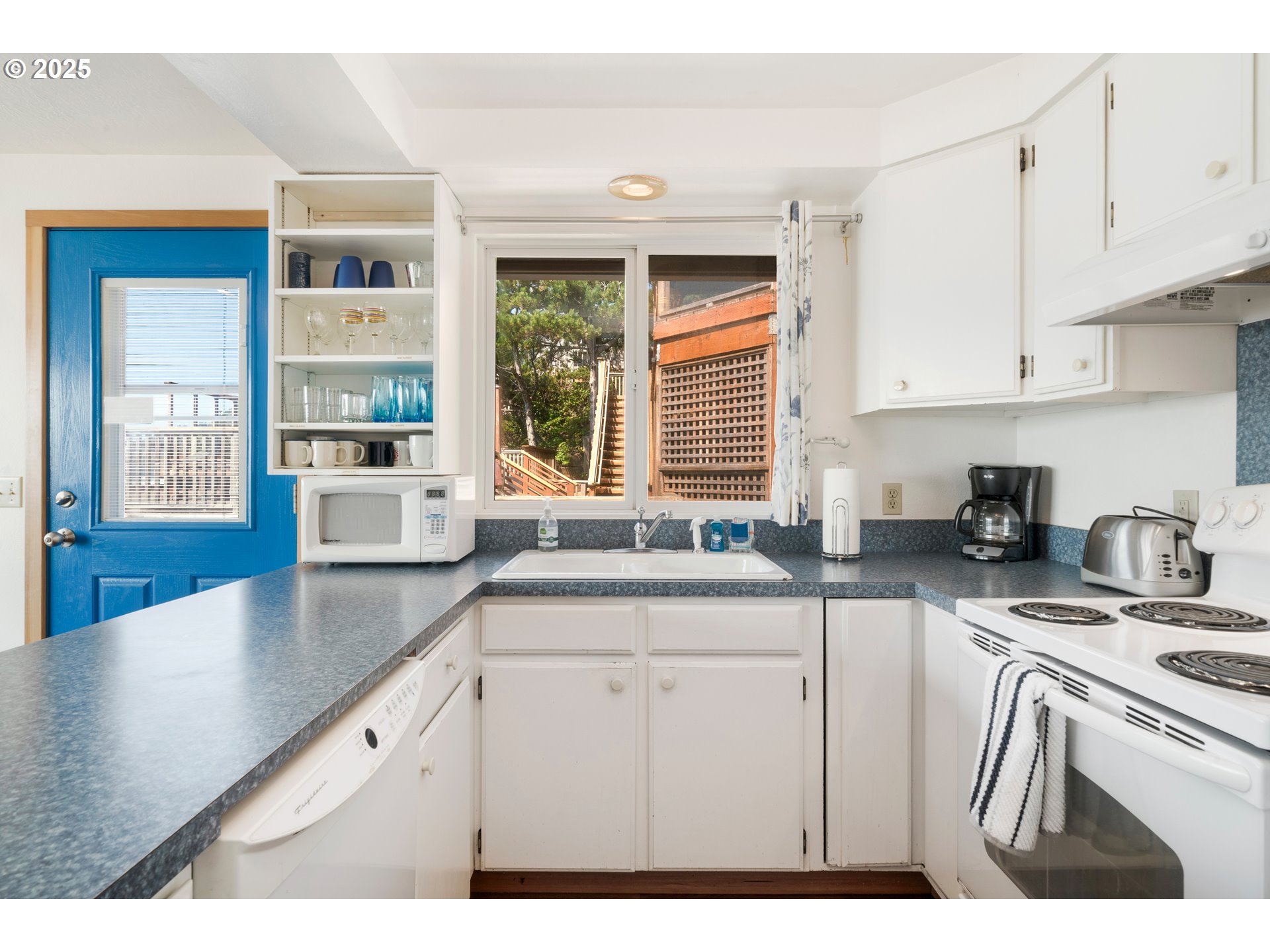 640 Ocean Road Manzanita, OR 97130 - Photo 12 of 47 a kitchen with stainless steel appliances granite countertop a sink stove and cabinets