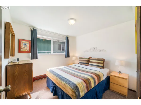 a bedroom with bed and window