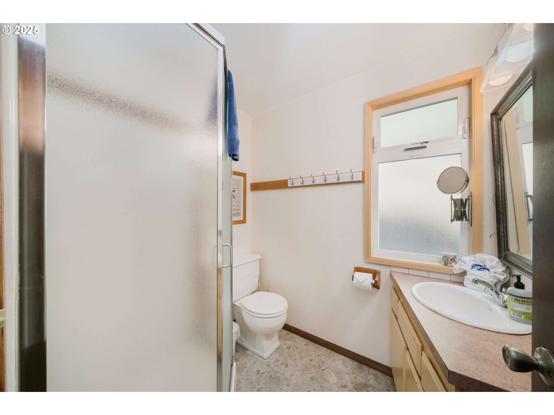 640 Ocean Road Manzanita, OR 97130 - Photo 22 of 47 a bathroom with a sink toilet double vanity and mirror
