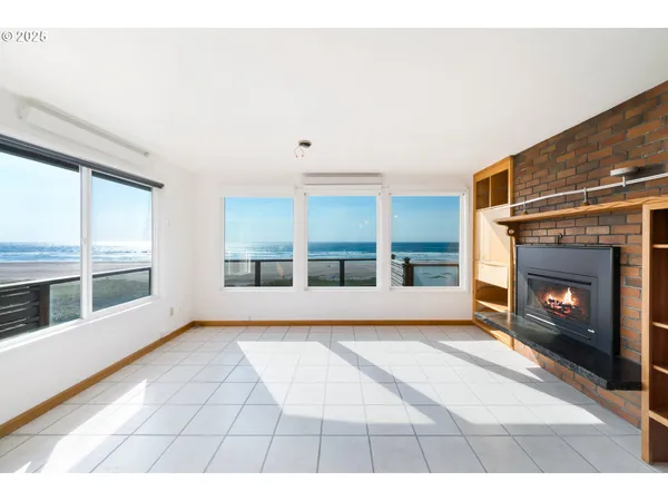 a view of an empty room with a fireplace
