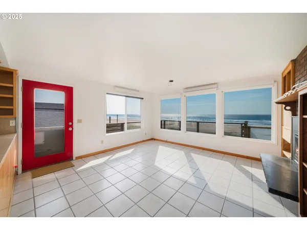 a living room with a couch a fireplace and a floor to ceiling window
