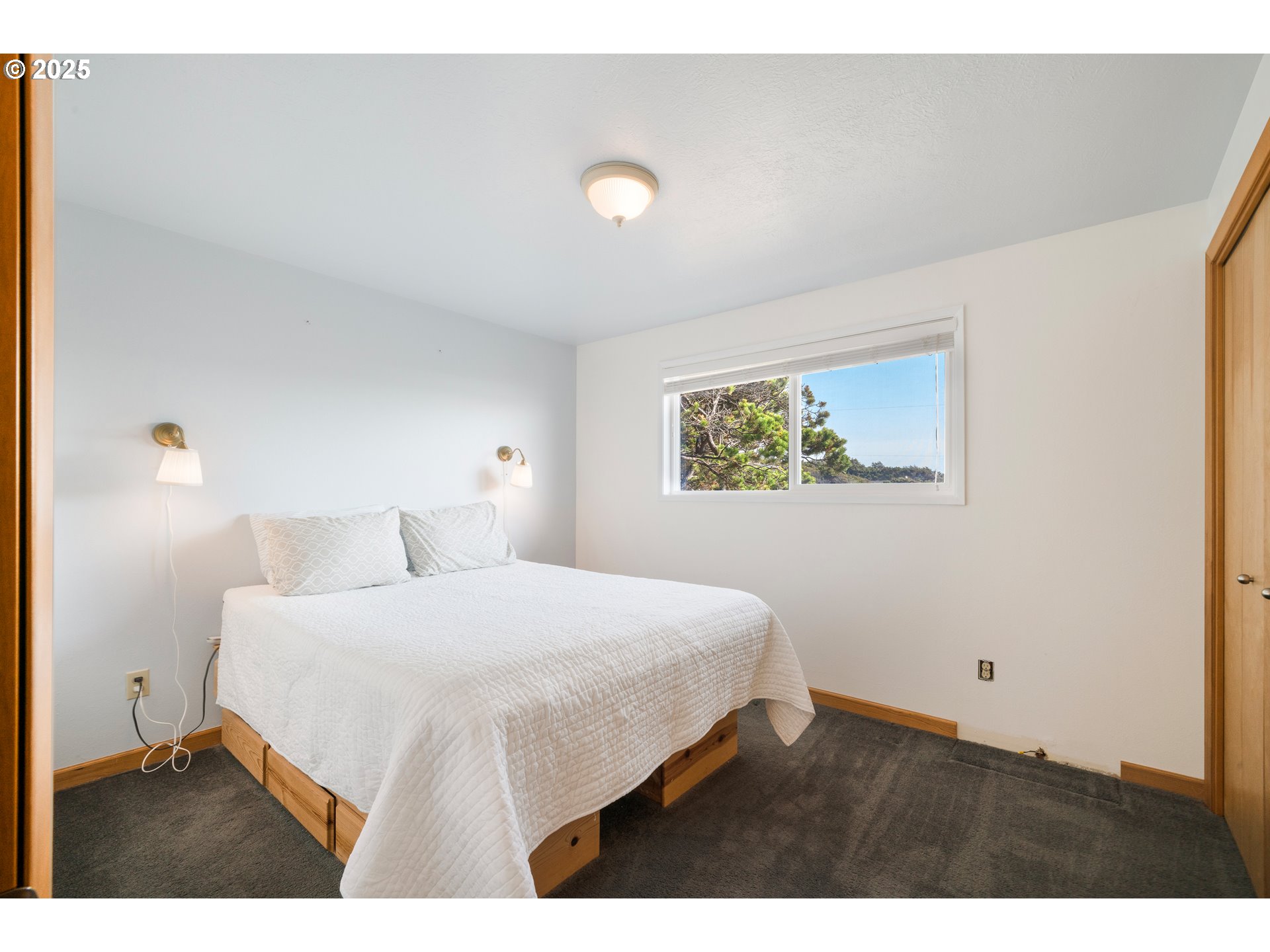 640 Ocean Road Manzanita, OR 97130 - Photo 32 of 47 a bedroom with a bed and a night stand