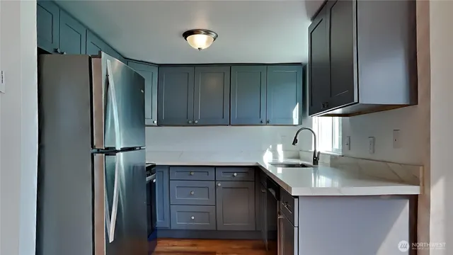 a kitchen with a refrigerator and a sink