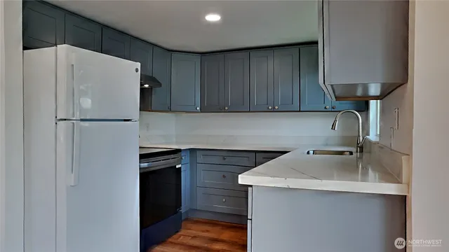 a white refrigerator freezer sitting inside of a kitchen