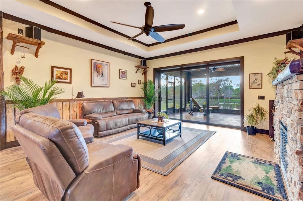 7330 Crabgrass Road St. Cloud, FL 34773 - Photo 12 of 60 a living room with fireplace furniture and a floor to ceiling window
