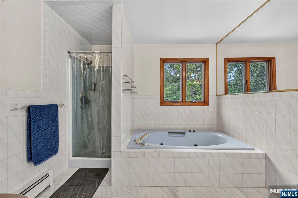 5110 Berkshire Valley Road Oak Ridge, NJ 07438 - Photo 37 of 49 a bathroom with a tub and shower