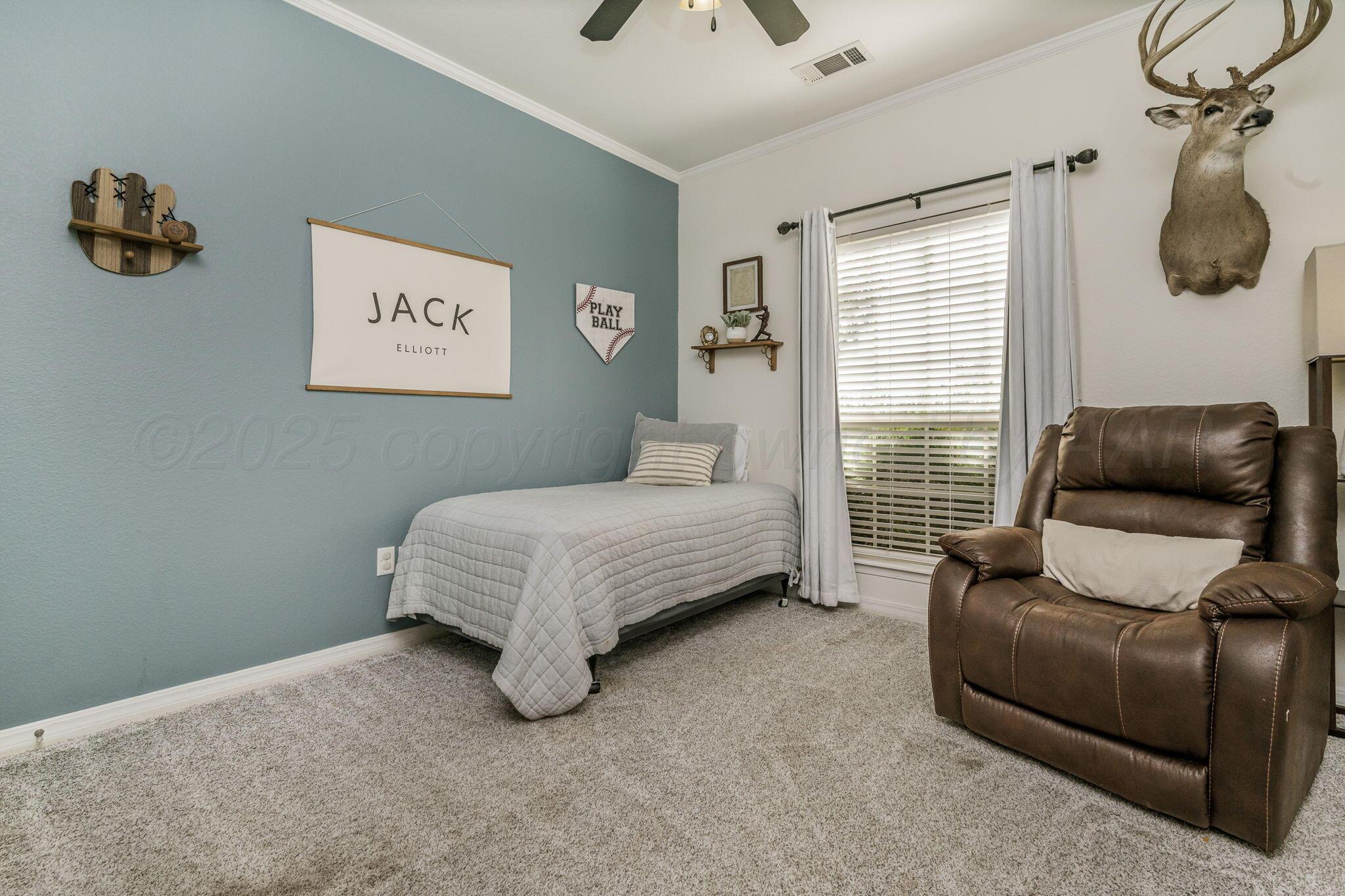 950 West Crane Road Pampa, TX 79065 - Photo 14 of 25 a bedroom with a bed and couch