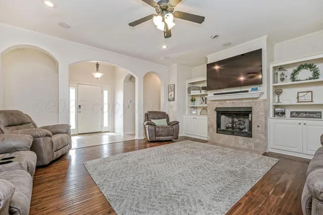 a living room with furniture flat screen tv and a fireplace