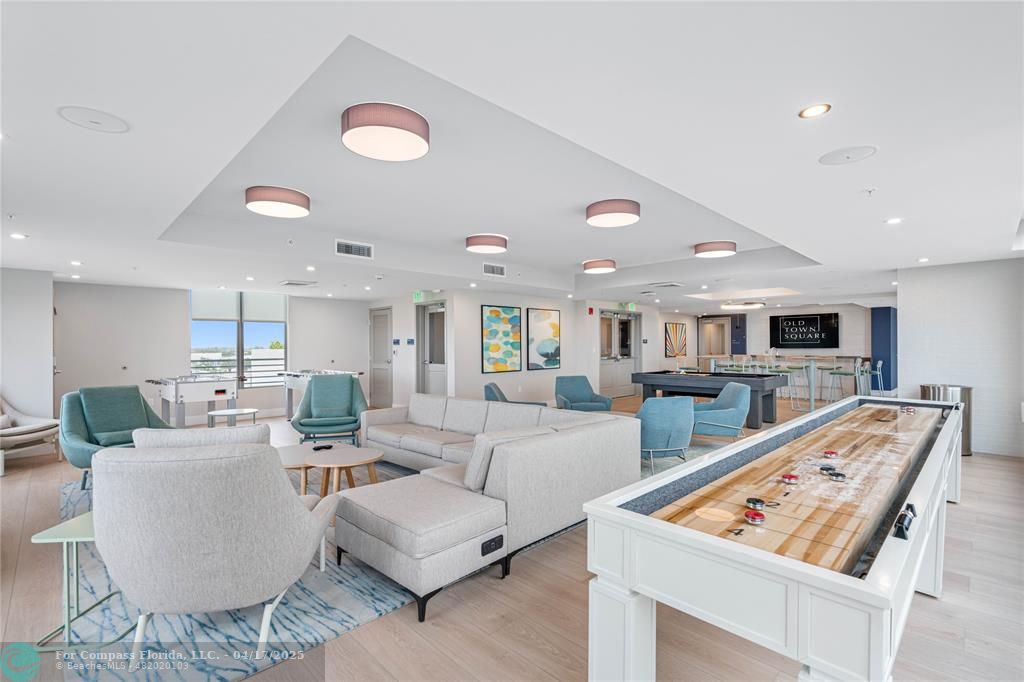 200 Northeast 1st Avenue, Unit 213 Pompano Beach, FL 33060 - Photo 11 of 23 a living room with furniture and flat screen tv