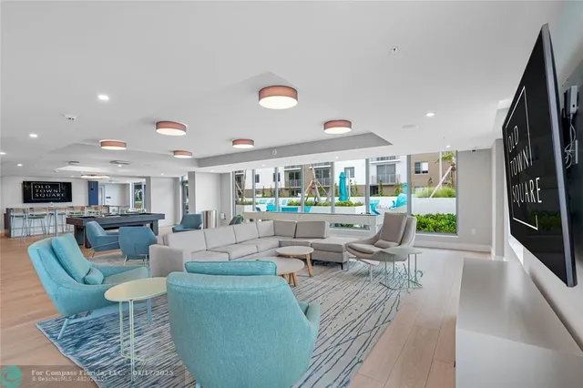 a living room with fireplace furniture and a large window