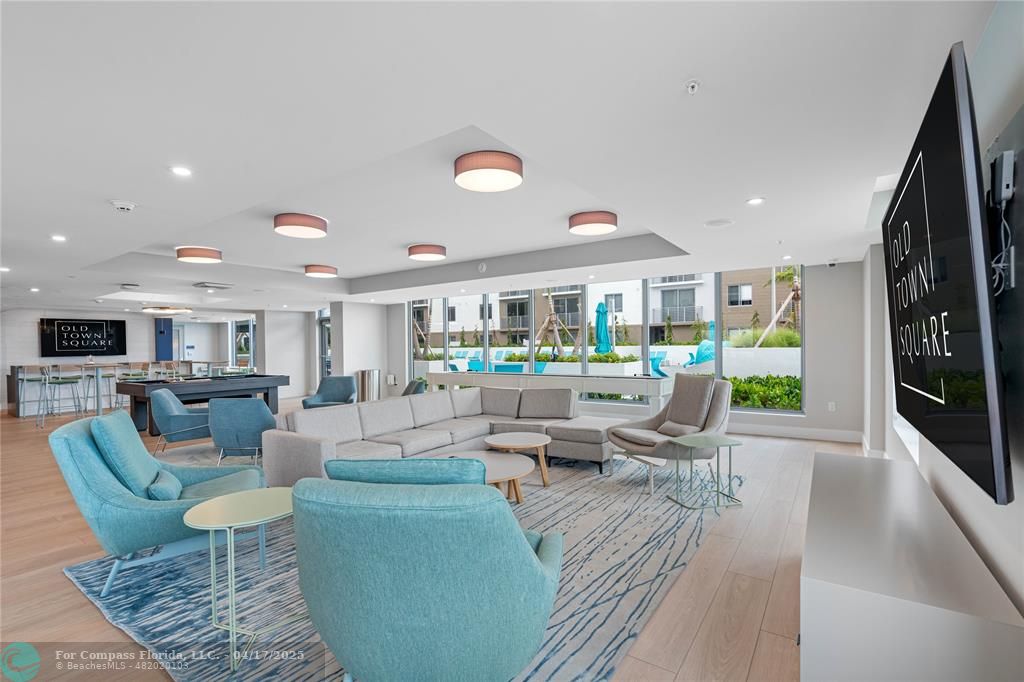 200 Northeast 1st Avenue, Unit 213 Pompano Beach, FL 33060 - Photo 13 of 23 a living room with fireplace furniture and a large window