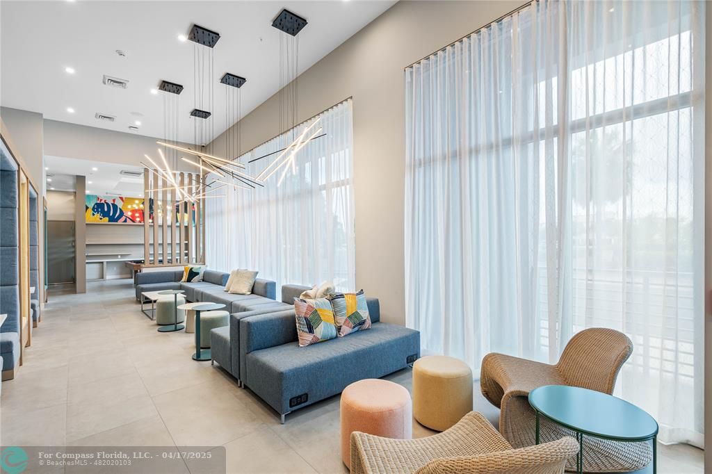 200 Northeast 1st Avenue, Unit 213 Pompano Beach, FL 33060 - Photo 16 of 23 a living room with furniture and a window