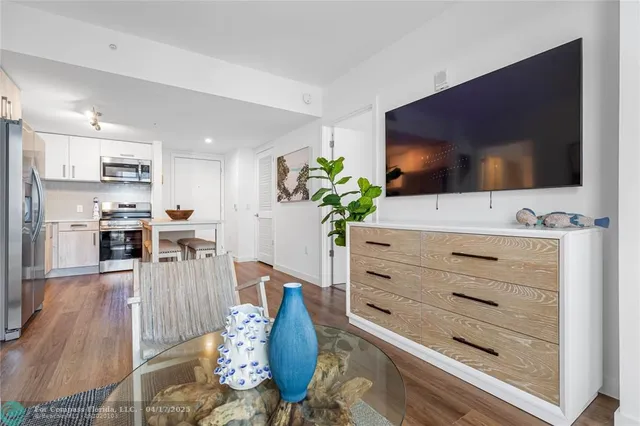 a living room with furniture flat screen tv and a potted plant