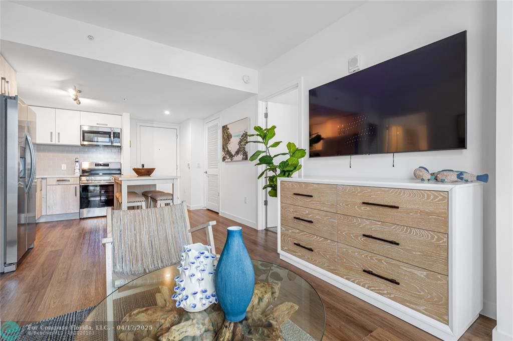 200 Northeast 1st Avenue, Unit 213 Pompano Beach, FL 33060 - Photo 2 of 23 a living room with furniture flat screen tv and a potted plant