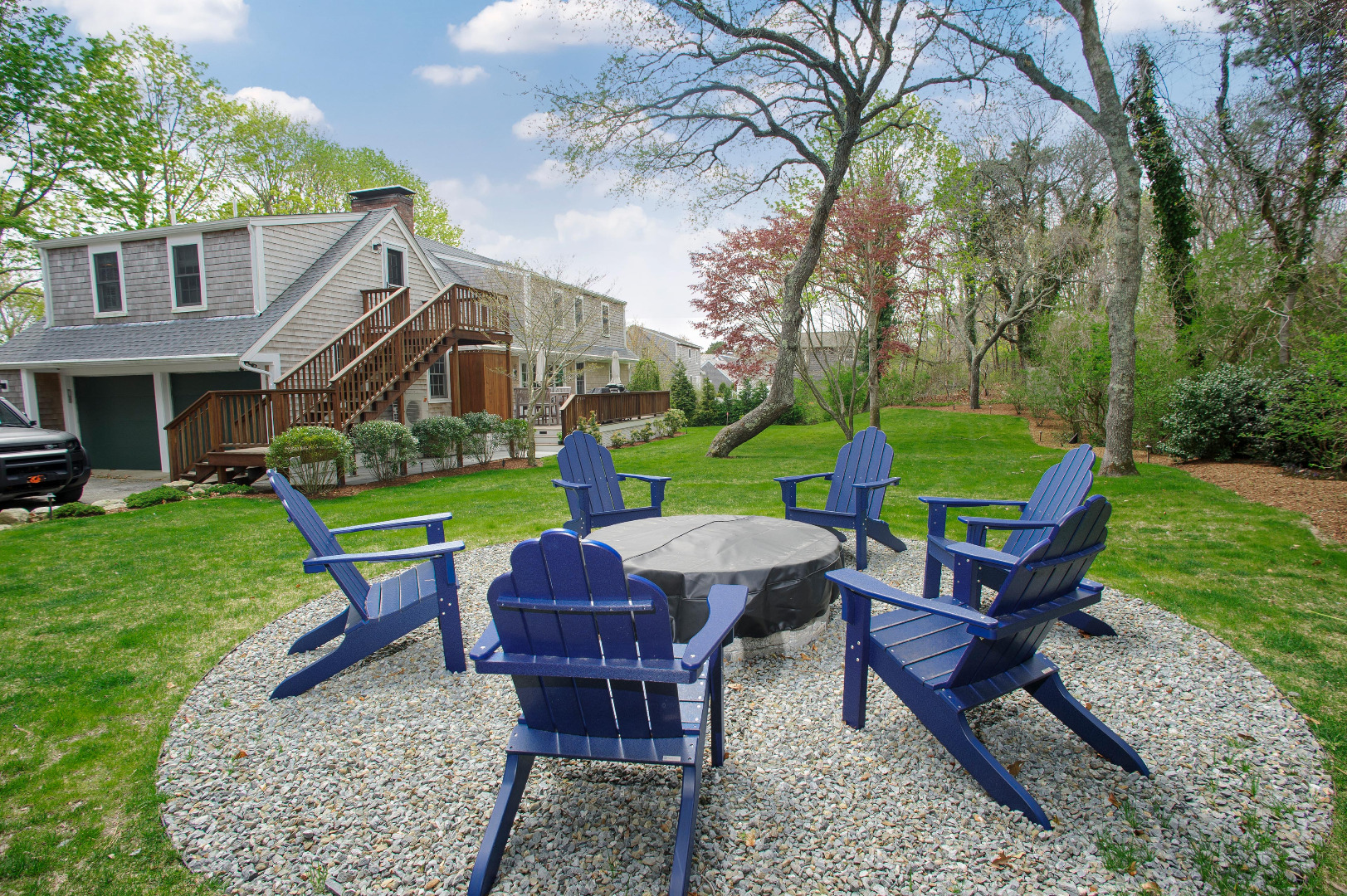 31 North Street Edgartown, MA 02539 - Photo 11 of 49 a view of a table and chairs in backyard of the house