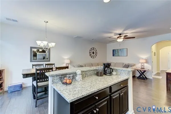 a kitchen with a counter space a sink and cabinets