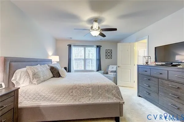 a bedroom with a large bed and a flat screen tv