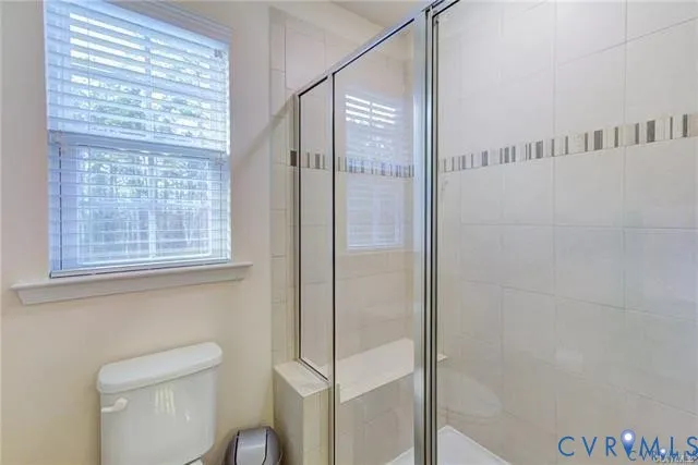 a bathroom with a shower and toilet