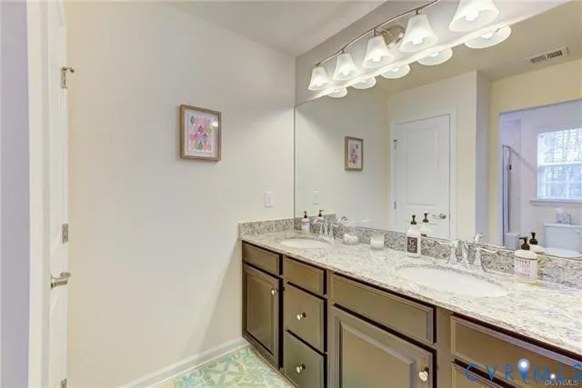 a bathroom with a double vanity sink and a mirror