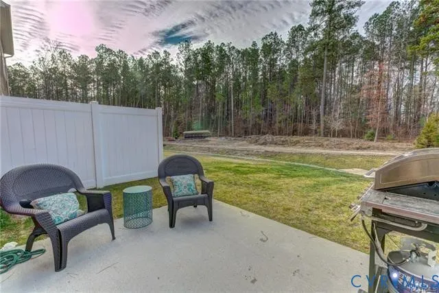 a view of a swimming pool with a yard and sitting area