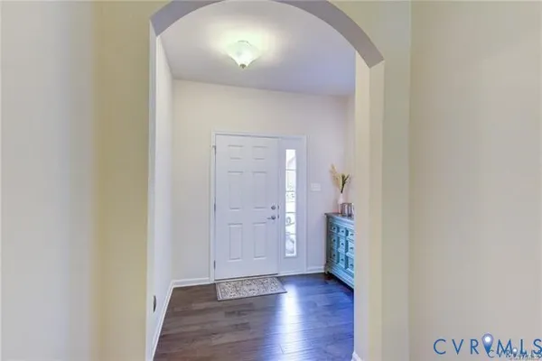 an empty room with wooden floor and a painting