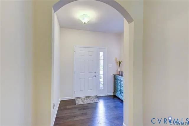 an empty room with wooden floor and a painting