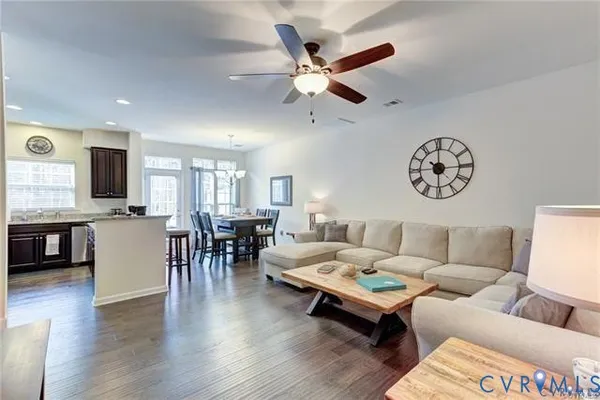 a living room with furniture and wooden floor