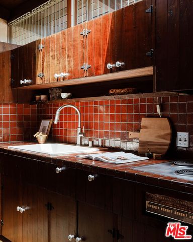 a kitchen with a sink and cabinets