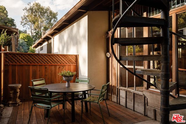 a backyard of a house with table and chairs