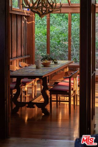 a balcony with wooden floor table and chairs