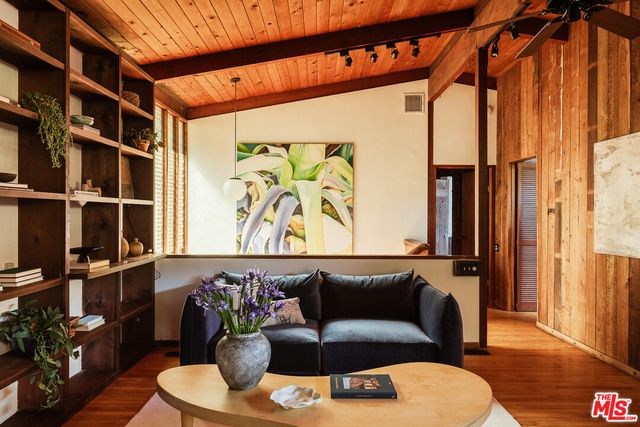 a living room with furniture a rug and a window