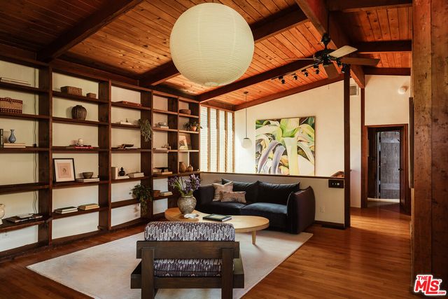 a living room with furniture a rug and a large window