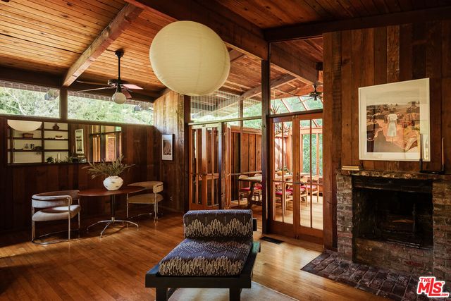 a living room with furniture a fireplace and a table