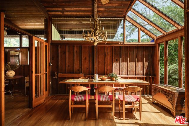 a view of a patio with table and chairs and wooden floor