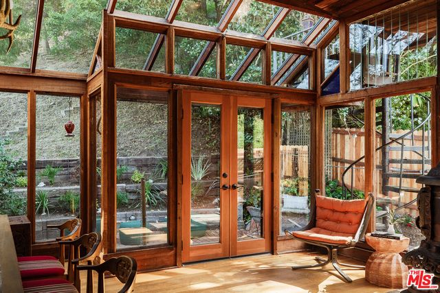 a porch with a bench next to a yard