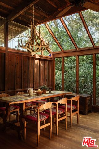 a view of a room with wooden floor and outdoor seating