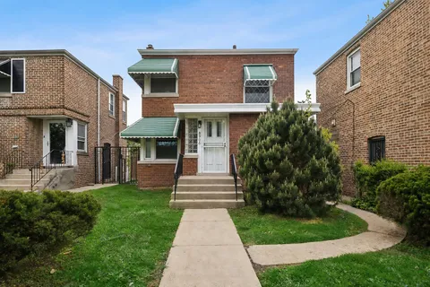 a front view of a house with a garden
