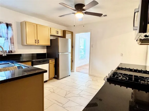 a kitchen with a stove and a refrigerator