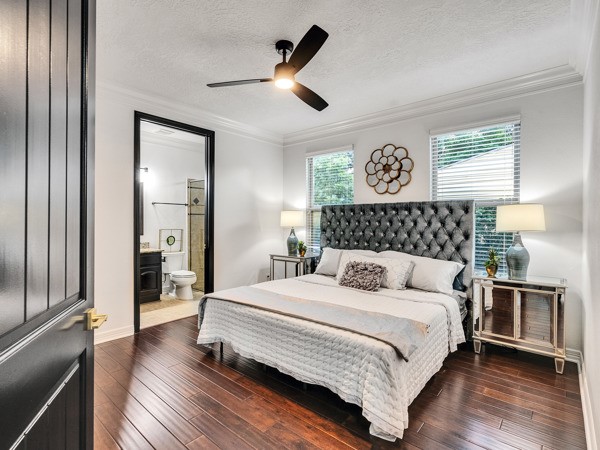 2523 Watts Street Houston, TX 77030 - Photo 12 of 45 a bedroom with a large bed and a chandelier