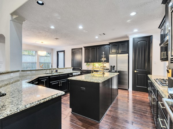 2523 Watts Street Houston, TX 77030 - Photo 6 of 45 a kitchen with kitchen island granite countertop a sink and stainless steel appliances