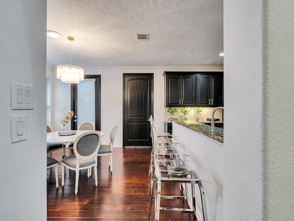 2523 Watts Street Houston, TX 77030 - Photo 7 of 45 a kitchen with stainless steel appliances kitchen island granite countertop a table and chairs in it