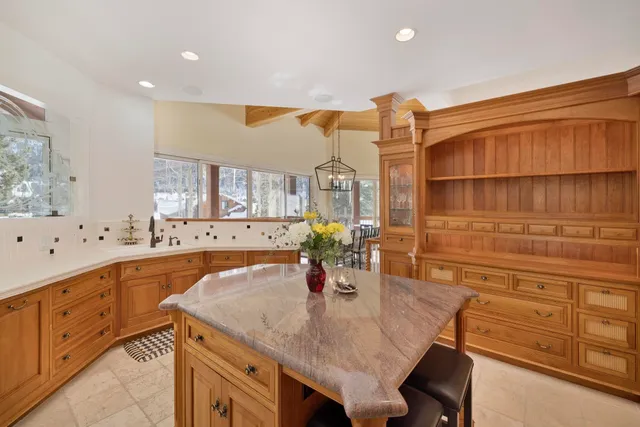 a kitchen with stainless steel appliances granite countertop a sink and cabinets