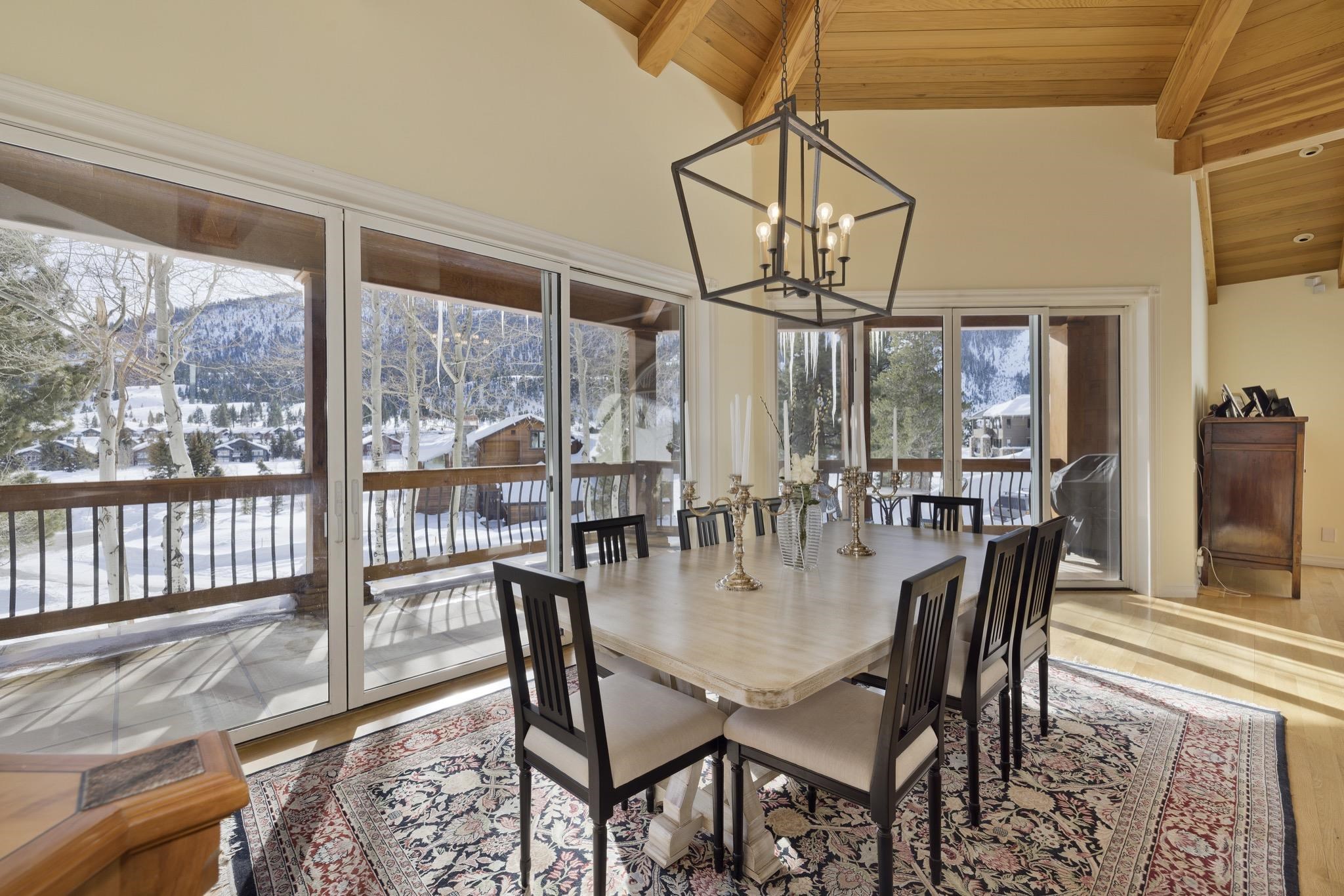 370 Ranch Road Mammoth Lakes, CA 93546 - Photo 13 of 46 Dining room with a wood ceiling with exposed beams, a chandelier, high vaulted ceiling, wood finished floors, and a mountain view