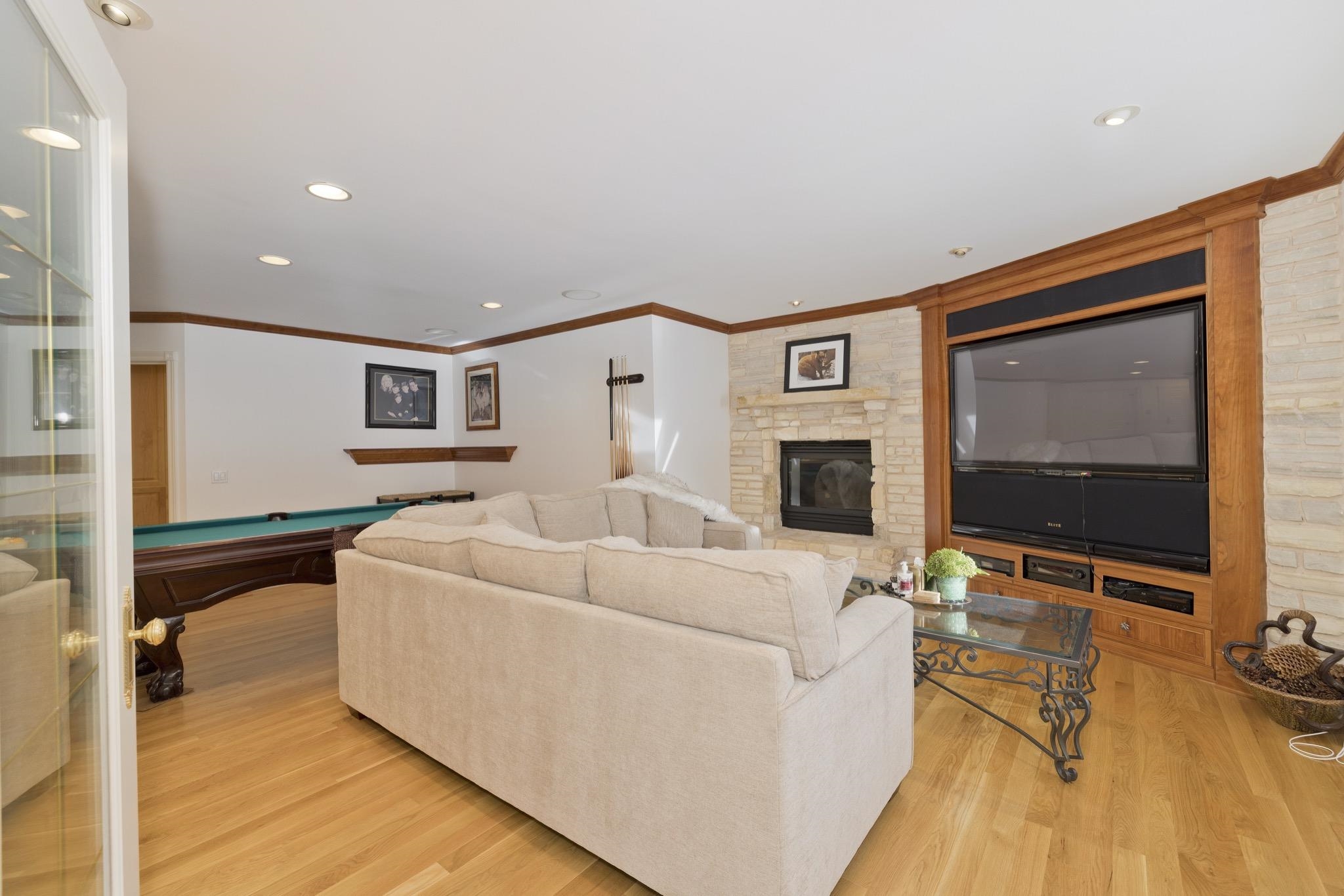 370 Ranch Road Mammoth Lakes, CA 93546 - Photo 21 of 46 Living area featuring pool table, light wood-style floors, ornamental molding, recessed lighting, and a fireplace