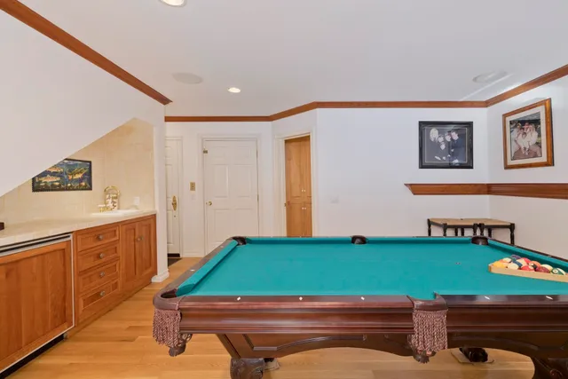 a room with pool table and windows